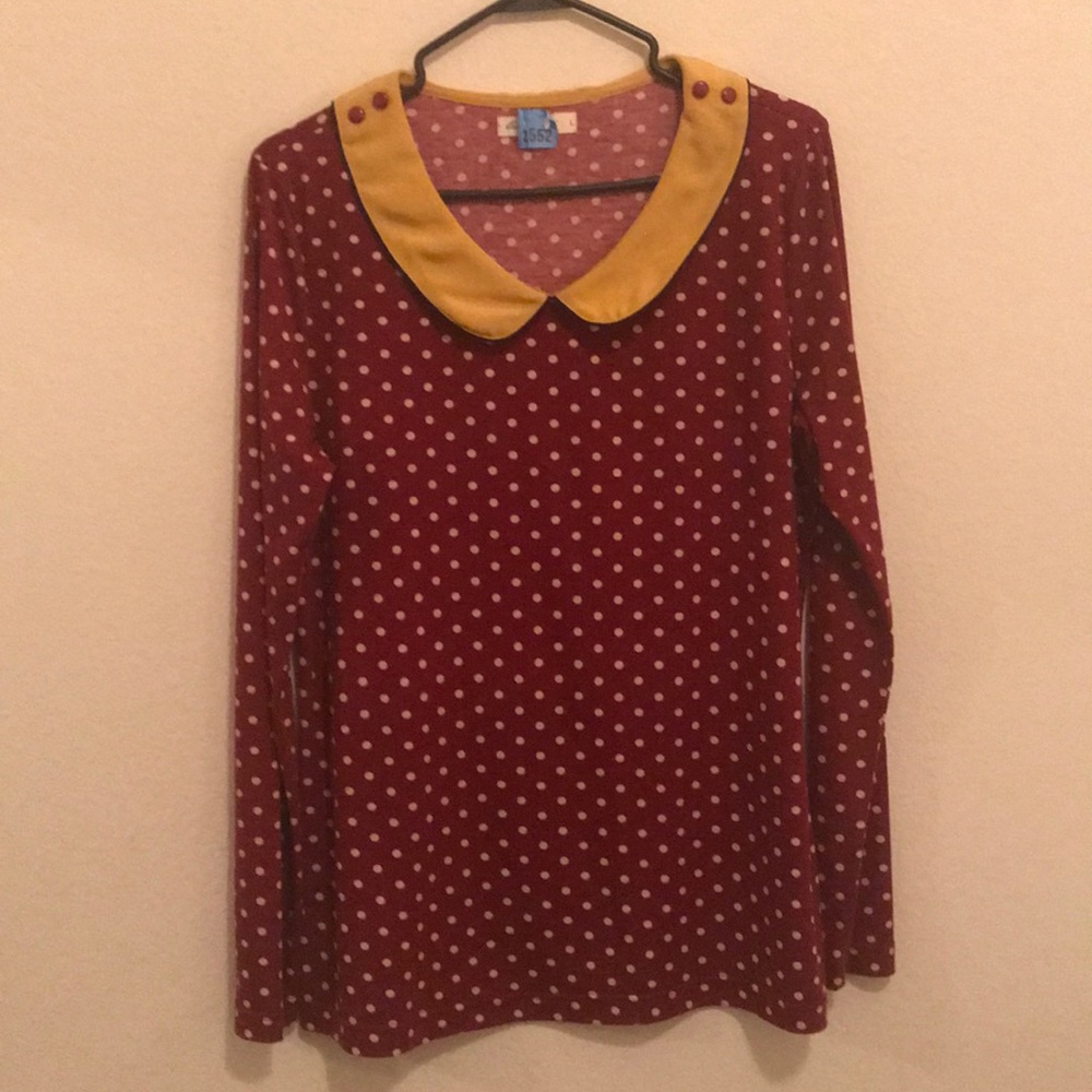 Red and mustard colored long-sleeve blouse